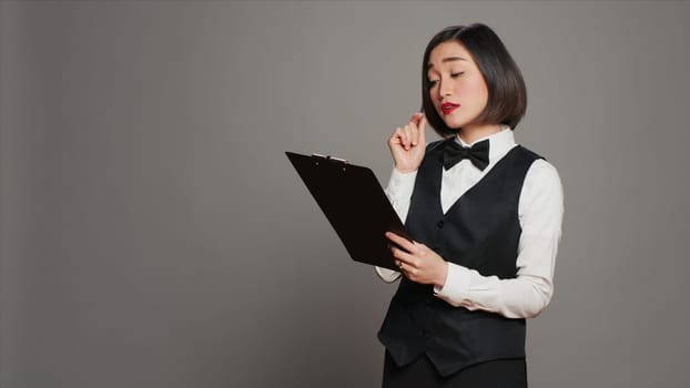 Hospitality industry worker making a list of reservations at hotel