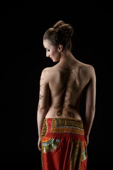 Mehndi. On woman's back henna pattern dreamcatcher