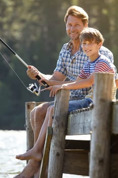 Lake, fishing or pole by father and son portrait in nature bonding, vacation or travel adventure. Fishing, love and kid with dad at river for learning, teaching or sustainable living while camping.