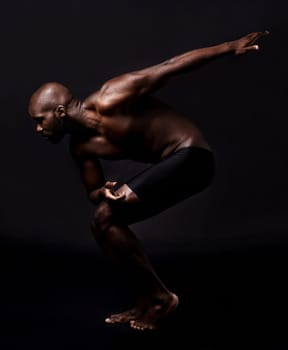Body, stretching and man on dark background with health, wellness and fitness or ready for running in studio. Young person, athlete or african model in art deco for dance, training or muscle training.