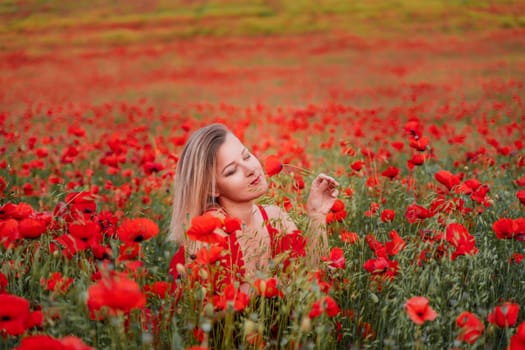 Happy woman in a red dress in a beautiful large poppy field. Blond sits in a red dress, posing on a large field of red poppies.