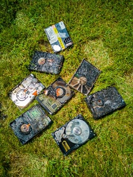 Burned hard drives lying on the green lawn