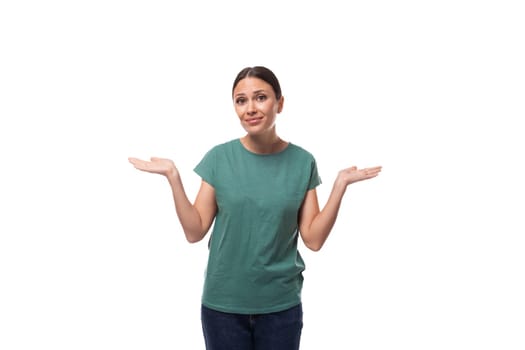 30 year old slender European brunette woman with ponytail hairstyle dressed in green t-shirt has doubts