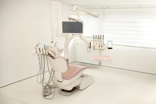 Pink dental chair in a modern dental office