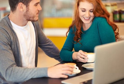 Laptop, restaurant and couple with coffee, date and bonding together with happiness and conversation. Love, cafe and computer with man and woman with smile and morning with cappuccino and cheerful