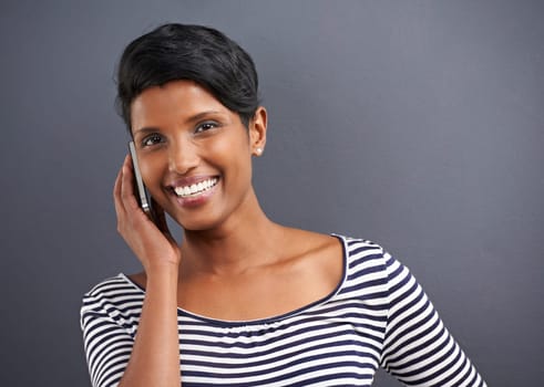Woman, portrait and phone call with confidence of a creative employee with grey background ready for work. Job, inspiration and happy Indian female worker with wondering and networking with style.