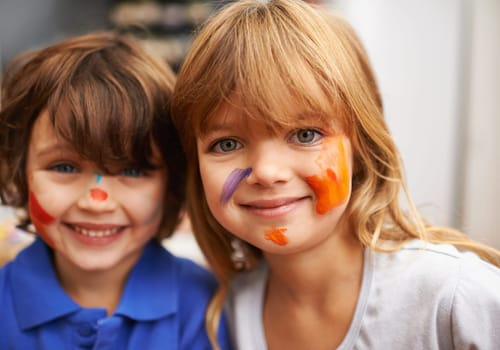 Happy children, portrait and face paint with color for artwork, craft or creativity at elementary school. Little girl, boy or kids with smile for colorful art, youth or early childhood development
