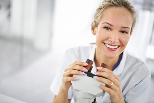 Happy woman, portrait and scientist with microscope for research, biology or forensics at lab. Face of female person or medical expert with smile for test, exam or scientific discovery at laboratory