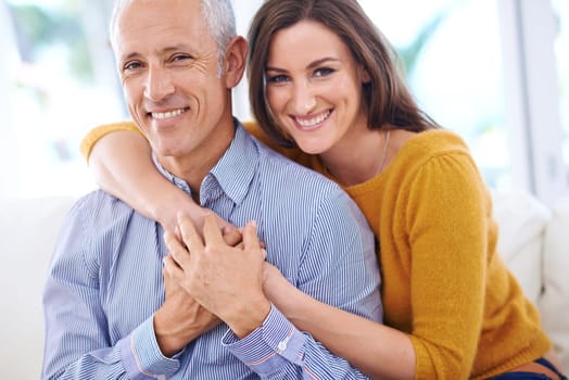 Happy, couple and hug in portrait, love with unique relationship and support for trust at home. Aged man, young woman and age difference in marriage, commitment and loyalty with pride together