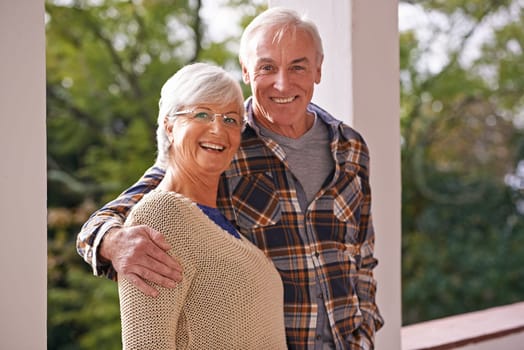 Couple, senior and portrait with hug, balcony and home for happy retirement. Mature man, woman and marriage with elderly, care and love for healthy relationship and romantic rest and relaxation