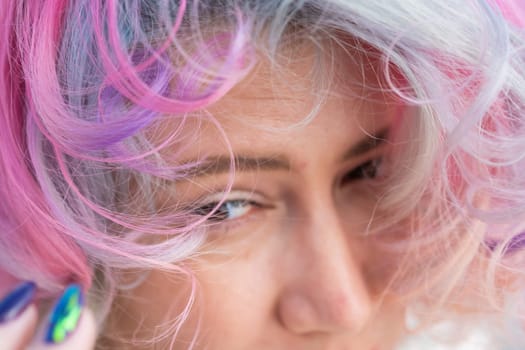 Cropped portrait of curly Caucasian woman with multi-colored hair. Model for hairstyles