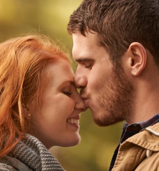 Date, kiss and couple closeup with love in park nature on holiday adventure or relax on vacation in woods. Together, man and woman with support and care in marriage and travel forest in morning