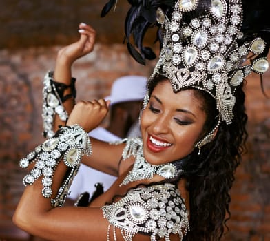 Performer, samba and dance with show, smile and makeup for concert or party. Brazilian woman, celebration and feather for culture, talent and creative artist for rio de janeiro carnival event.