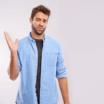 Smell, man and waving his hands for bad stink, poor hygiene and negative aroma on white studio background. Face, person or model with gesture or body odor with fart and disgust with yuck expression