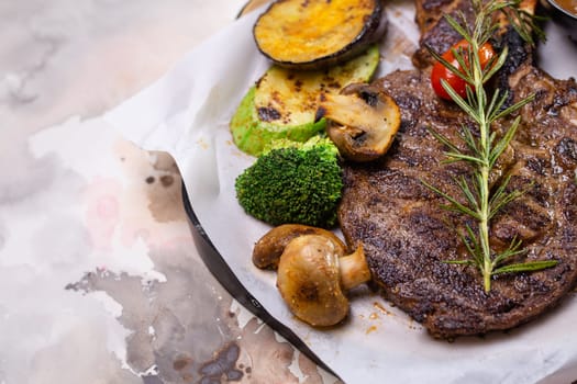 Grilled steak with vegetables and mushroom on white background