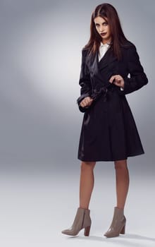 Coat, fashion space or woman in portrait or studio for cool style, trendy jacket or comfortable outfit. Chic, mockup or confident model in cozy heels or elegant winter clothing on grey background.