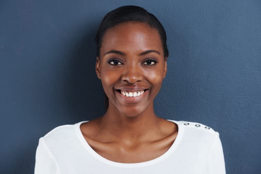 Black woman, smile portrait and studio for natural cosmetics for skincare and facial glow for beauty. African model, dermatology or happy face with mascara or confident in closeup by blue background