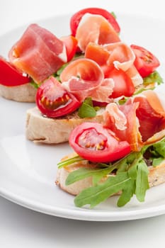 Jamon. Slices of Bread with Spanish Serrano Ham Served as Tapas. Cured ham, spanish appetizer. Prosciutto isolated on white background