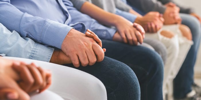 Closeup Of Addicted People Holding Hands Together On Therapy Group Meeting In Rehab, Cropped Image, Panorama