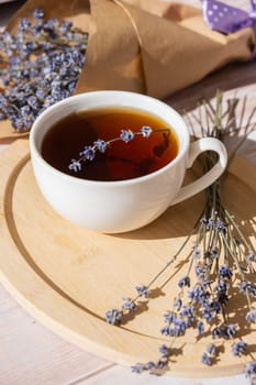 Healthy homemade cup of lavender tea. Organic natural home grown herb for teas. White cup of tea with dried lavender flowers. Healthy living wellbeing