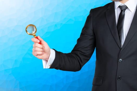 business man holding magnifying glass concept