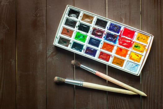 Set of watercolor paints and paintbrushes for painting