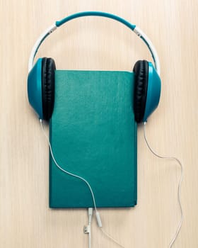 Audio books concept with old book and headphones