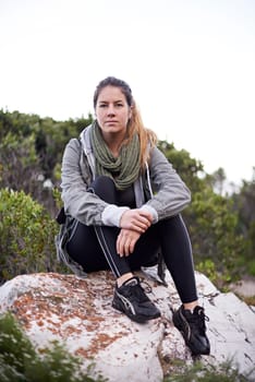 Woman, mountain and relax on hiking break in forest for leisure or fitness routine to exercise and workout. Portrait, female person and outdoor on hill with nature, peace and adventure on holiday.