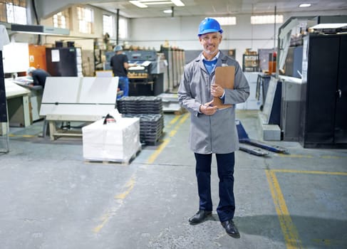 Portrait, man or clipboard in packaging, safety or helmet as product, logistics or industry by stock. Happy, inspector or checklist in quality control, industrial or inspection of inventory on site