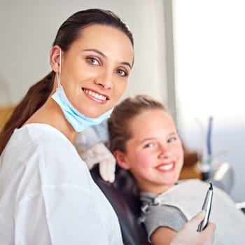 Portrait, dentist and woman with tools for happy child in medical exam, orthodontics or cleaning teeth. Face, smile and dental doctor with kid for tooth care, oral health or pediatrician with laser