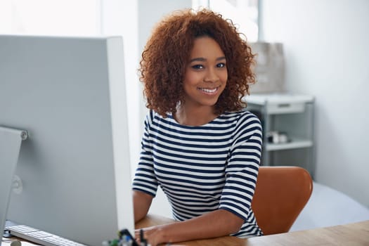 Creative, office and portrait of black woman at computer with productivity on project or writing email. Happy, employee and working at desktop with development on task and typing online communication.