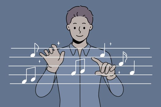 Man conductor moves hands, standing near imaginary notes and comes up with new musical composition