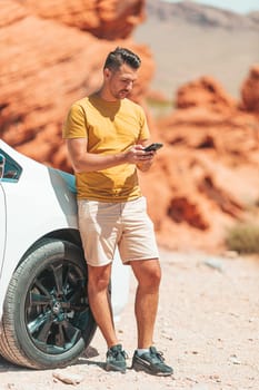 Man with smartphone on trail in national park in Nevada