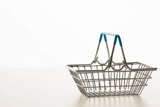 Wire shopping basket isolated on a white background
