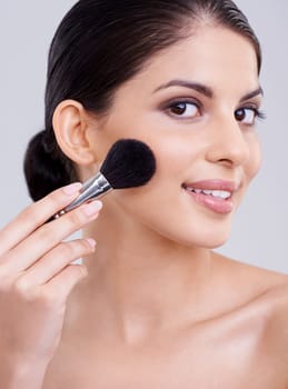 Woman, portrait and makeup brush in studio for beauty blush, cosmetics or grey background. Female person, facial contour and treatment transformation for makeover wellness, mockup space or routine