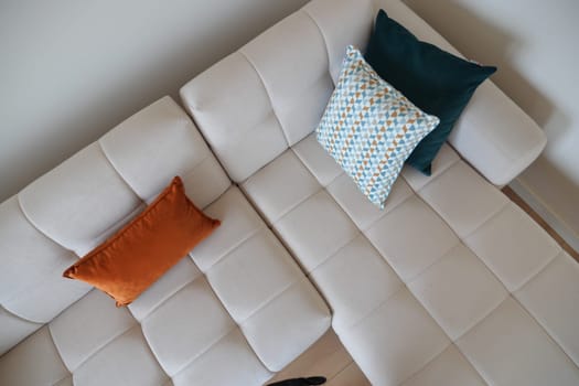 top view of modern sofa with pillows in living room at home