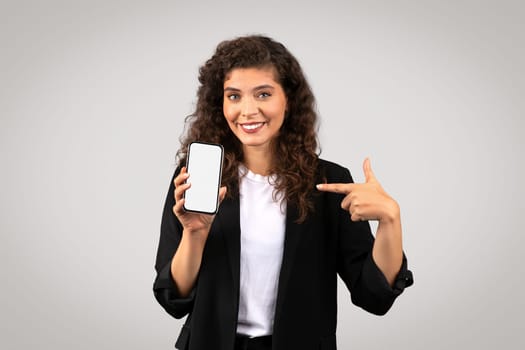 Woman showing smartphone screen to camera