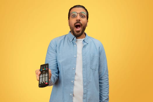 Shocked indian man with a remote control
