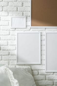 Varied Sized Photo Frames Displayed on a White Brick Wall