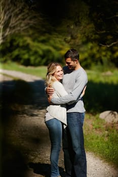 Couple, hug and happiness in park for love, bonding with care and support in healthy relationship. Man, woman and smile outdoor for date with romance, trust and commitment for marriage or partner