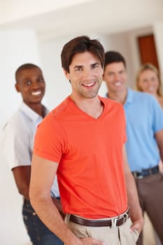 Portrait, happy man and professional in office with people for working, business and agency career. Male worker, employee and smile in workplace with happiness for coworking, together and teamwork