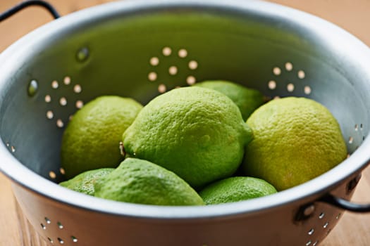 Closeup of fruit, lime and healthy food for snack, nutrition and wellness with citrus for vitamin c or detox. Organic ingredients, fresh green produce and balance in diet, sweet or sour for juice