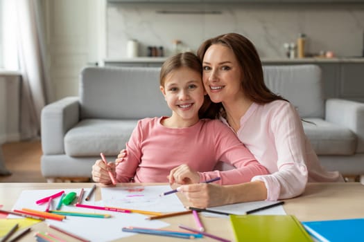 Mother and daughter smiling during art time