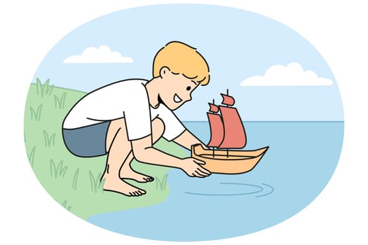 Happy child launch toy boat on water