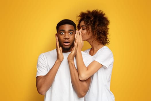 Black woman whispering her desires to shocked boyfriend