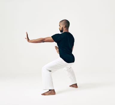 Man, studio and martial arts for defense practice, action and karate exercise on white background. Black male person, mockup space and training for combat, fight and position of attack in taekwondo