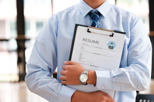 Close-Up of Businessman Holding a Resume.