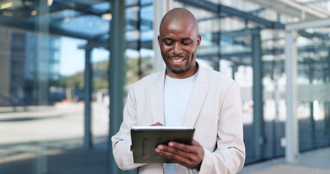 Black man, tablet and typing in city, commute and online, digital and technology. Working, cape town and busy in urban area, office buildings and businessman for networking and checking email