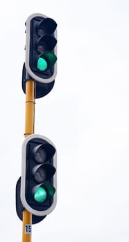 Traffic light, green and city intersection on street for go instruction, transportation or downtown. Road safety, commute and urban rules for traveling directions or infrastructure, driving or public