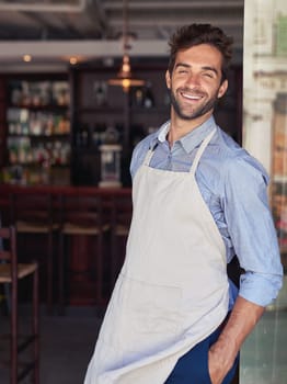 Industry, smile and portrait of waiter in coffee shop with confidence for hospitality career. Happy, pride and male barista standing with positive attitude in restaurant or cafe for food service